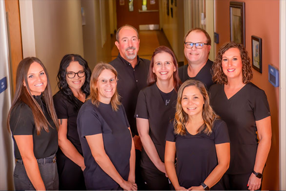 Smiling group picture of two males and six females.